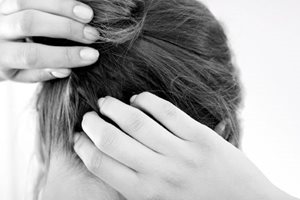 Mujer rascándose el cuero cabelludo pruriginoso